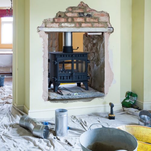 Installing a double-sided wood burning stove during a UK home improvement project