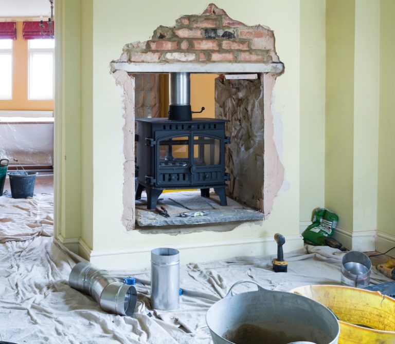 Installing a double-sided wood burning stove during a UK home improvement project